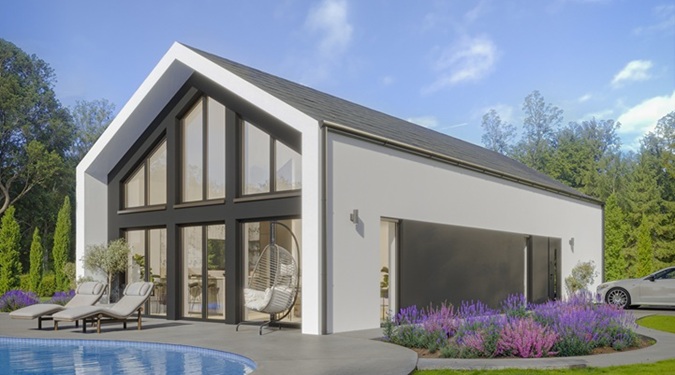 Elegante casa estilo granero compacta ubicada en un entorno natural boscoso.