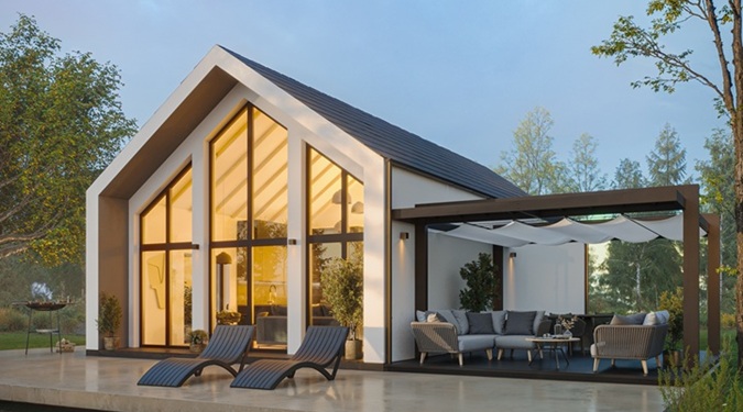 Casa estilo granero moderna con ventanales de suelo a techo y terrazas exteriores.